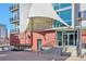 The Monarch Mills building entrance is inviting with artistic awning and brickwork along with clear glass doors at 1475 Delgany St # 807, Denver, CO 80202