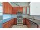 Updated kitchen with granite countertops, stainless steel appliances, white backsplash and wooden cabinets at 1475 Delgany St # 807, Denver, CO 80202