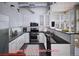 Modern white kitchen with stainless steel appliances, dark countertops and wood-look floors at 1475 Delgany St # 807, Denver, CO 80202