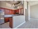 Modern kitchen with pendant lighting, breakfast bar, stainless steel appliances, and wood cabinets at 1475 Delgany St # 807, Denver, CO 80202