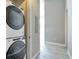Convenient laundry room with stacked washer and dryer and access to a hallway at 1475 Delgany St # 807, Denver, CO 80202