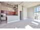 Bright living room with light grey tile floors, exposed duct work, and large windows for lots of light at 1475 Delgany St # 807, Denver, CO 80202