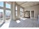Bright, open living room featuring large windows, concrete pillars, wood floors and oversized mirror at 1475 Delgany St # 807, Denver, CO 80202