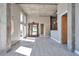 Open living space with oversized mirror, hardwood style floors, concrete pillars and high ceilings at 1475 Delgany St # 807, Denver, CO 80202