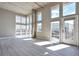 Bright and airy living room featuring tall windows, hardwood floors and concrete pillars at 1475 Delgany St # 807, Denver, CO 80202