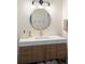 Bathroom with a round mirror, modern vanity, and gold faucet at 5103 Quitman St, Denver, CO 80212