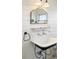 Close-up of bathroom sink with unique mirror, open shelving, and wall paneling at 5103 Quitman St, Denver, CO 80212