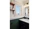 Stylish bathroom featuring modern fixtures, a vintage mirror, and open shelving for a spa-like feel at 5103 Quitman St, Denver, CO 80212