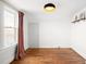 Bedroom with hardwood floors, neutral walls, closet, and a window with dark curtains at 5103 Quitman St, Denver, CO 80212