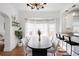Bright dining room featuring a large window, modern chandelier, and stylish table with comfortable seating at 5103 Quitman St, Denver, CO 80212