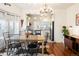 Bright dining room with hardwood floors, table, and a view into the kitchen at 5103 Quitman St, Denver, CO 80212