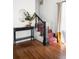Entryway features a wooden floor, staircase with red accents, and black console table at 5103 Quitman St, Denver, CO 80212