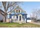 Charming blue two-story home with a front porch, garage, and beautifully landscaped front yard at 5103 Quitman St, Denver, CO 80212