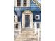 Close-up of the front door with decorative wreath, complemented by stylish columns and a welcoming entrance at 5103 Quitman St, Denver, CO 80212