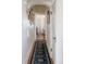 Arched hallway featuring stylish runner, elegant wall decor, and hardwood floors creating a warm welcome at 5103 Quitman St, Denver, CO 80212
