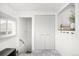 Bright hallway with brick floors, closet, and access to the basement stairs at 5103 Quitman St, Denver, CO 80212