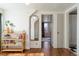 Hallway featuring wood floors, decorative shelving, and a view of a bedroom at 5103 Quitman St, Denver, CO 80212