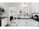 Bright kitchen showcasing white cabinetry, black countertops, and modern fixtures with connecting breakfast nook at 5103 Quitman St, Denver, CO 80212