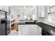 Spacious kitchen with stainless steel appliances, white cabinets, and modern finishes with an open layout at 5103 Quitman St, Denver, CO 80212