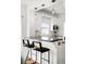 Cozy kitchen bar area with pendant lighting and stylish seating, perfect for casual dining and entertaining at 5103 Quitman St, Denver, CO 80212