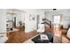 Open living area with hardwood floors, staircase, and seamless flow to dining, ideal for modern living at 5103 Quitman St, Denver, CO 80212