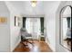 Bright sitting room with hardwood floors, gray rocking chair, and green curtains at 5103 Quitman St, Denver, CO 80212