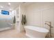 Luxurious bathroom featuring a soaking tub, a glass-enclosed shower, and designer fixtures at 1120 S Gaylord St, Denver, CO 80210