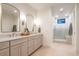 Beautiful bathroom with double vanity, large mirrors, stylish fixtures, and a walk-in shower at 1120 S Gaylord St, Denver, CO 80210