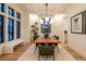 Elegant dining room featuring stylish chandelier, modern furniture, and a bright, inviting atmosphere at 1120 S Gaylord St, Denver, CO 80210