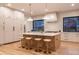 Bright kitchen features a large island with counter seating, modern appliances, and beautiful light wood floors at 1120 S Gaylord St, Denver, CO 80210