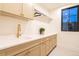 Well-lit laundry room with undermount sink and modern fixtures at 1120 S Gaylord St, Denver, CO 80210