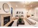 Elegant living room features a fireplace, stylish decor, large windows, and neutral color palette at 1120 S Gaylord St, Denver, CO 80210