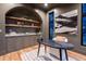 Well-designed home office featuring built-in shelving, a unique desk, and contemporary artwork at 1120 S Gaylord St, Denver, CO 80210