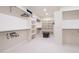 Spacious walk-in closet with custom shelving, carpeted floors and seating area at 1120 S Gaylord St, Denver, CO 80210