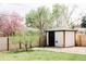 Charming backyard featuring a storage shed and beautiful landscaping behind a wood fence at 3890 Moore St, Wheat Ridge, CO 80033