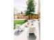 Charming patio with comfortable seating, overlooking a well-maintained backyard and privacy fence at 3890 Moore St, Wheat Ridge, CO 80033