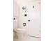This is a bathroom with white toilet, wall mounted mirror, and light switches at 3890 Moore St, Wheat Ridge, CO 80033