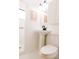 White bathroom with bright lighting and stylish pedestal sink at 3890 Moore St, Wheat Ridge, CO 80033