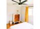 Bright bedroom featuring hardwood floors, stylish dresser, and fan at 3890 Moore St, Wheat Ridge, CO 80033