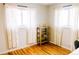 Bright bedroom with hardwood floors, shelf, and natural light at 3890 Moore St, Wheat Ridge, CO 80033