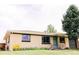 Inviting one-story brick home with well-manicured front yard and curb appeal at 3890 Moore St, Wheat Ridge, CO 80033
