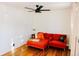 Bright living room featuring hardwood floors, a cozy sectional, and modern design with orange accents and black ceiling fan at 3890 Moore St, Wheat Ridge, CO 80033
