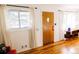 Entry of a charming home showcasing hardwood floors, a stylish front door, and inviting natural light from the adjacent windows at 3890 Moore St, Wheat Ridge, CO 80033