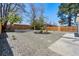 Spacious backyard with gravel, modern landscaping, and a wooden fence bordering the property at 4745 N Clay St, Denver, CO 80211
