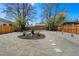 Well-maintained backyard features gravel, landscaping, stepping stones, and a sturdy wooden fence at 4745 N Clay St, Denver, CO 80211