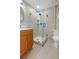 Modern bathroom features a glass enclosed shower, stylish tile, and a wood vanity with lots of storage at 4745 N Clay St, Denver, CO 80211
