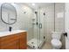 Stylish bathroom featuring a glass shower, decorative tile, and a modern vanity with sink at 4745 N Clay St, Denver, CO 80211