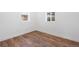 Unfurnished bedroom with wood floors, neutral walls, and natural light from two windows at 4745 N Clay St, Denver, CO 80211