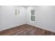 Empty bedroom showcasing hardwood floors, natural lighting, and fresh white paint ready for decor at 4745 N Clay St, Denver, CO 80211