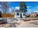Charming home with low maintenance front yard featuring gravel landscaping and a long, wide concrete driveway at 4745 N Clay St, Denver, CO 80211